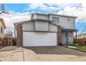 Two-story house with attached garage and basketball hoop at 6119 Zenobia Ct, Arvada, CO 80003