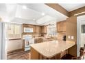 Well-lit kitchen with wooden cabinets, a large island, and modern appliances at 6119 Zenobia Ct, Arvada, CO 80003