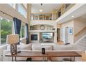 Spacious living room with soaring ceilings, fireplace, and abundant natural light at 9158 Forest St, Firestone, CO 80504