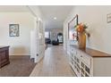 Inviting foyer with neutral tile floors, an accent cabinet, and views into the living area at 3008 Echo Park Dr, Castle Rock, CO 80104