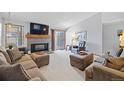 Comfortable living room with a fireplace, plush seating, and a sliding glass door providing natural light at 5370 W 74Th Ave, Arvada, CO 80003