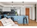 Modern kitchen with a large island, stainless steel appliances, and light blue cabinetry at 601 W 11Th Ave # 910, Denver, CO 80204