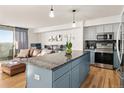 Bright, open kitchen featuring granite counters, stainless appliances, and an adjacent living area at 601 W 11Th Ave # 910, Denver, CO 80204