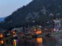 Night view of community with mountain backdrop and lights reflecting off the river at 1890 Argentine St # D203, Georgetown, CO 80444