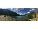 Panoramic view of a serene lake surrounded by mountains under a cloudy sky at 1890 Argentine St # D203, Georgetown, CO 80444