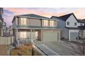Charming two-story home with a two-car garage and welcoming front porch at dusk at 5318 Truckee St, Denver, CO 80249