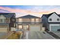 Charming two-story home with a two-car garage and welcoming front porch under a colorful sky at 5318 Truckee St, Denver, CO 80249