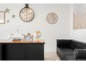 Well-lit home office with a large desk and a comfortable black leather sofa at 5318 Truckee St, Denver, CO 80249