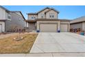 Beautiful home boasting a three-car garage, green lawn, and welcoming front porch for relaxing and entertaining at 12863 Crane River Dr, Firestone, CO 80504