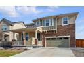 Inviting two-story home with a stone facade, covered porch, and well-maintained lawn at 236 Back Nine Dr, Castle Pines, CO 80108