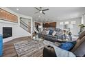 Comfortable living room with a fireplace, ceiling fan and an open layout at 236 Back Nine Dr, Castle Pines, CO 80108