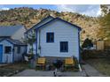 Back exterior view with outdoor seating and space, perfect for relaxing or entertaining at 215 Colorado Blvd, Idaho Springs, CO 80452