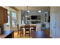 Dining room with large windows, an elegant table and view into the living room at 8024 W 95Th Way, Broomfield, CO 80021