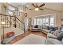 Spacious living room with hardwood floors, staircase and lots of natural light at 14558 Vine St, Thornton, CO 80602