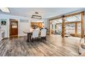 Open dining area with wood-look floors, adjacent to a cozy living room at 11531 S Deer Creek Rd, Littleton, CO 80127