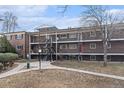 Brick apartment building with walkways and covered entrances, set in a landscaped common area at 6800 E Tennessee Ave # 411, Denver, CO 80224