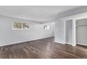 Spacious living room features wood-look floors and bright natural light from multi-paned windows at 6800 E Tennessee Ave # 411, Denver, CO 80224
