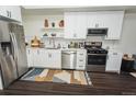 Modern kitchen with stainless steel appliances, white cabinets, and a stylish backsplash at 2876 W 53Rd Ave # 106, Denver, CO 80221