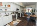 Open-concept layout showcasing a kitchen with a view into the living and dining areas at 2876 W 53Rd Ave # 106, Denver, CO 80221