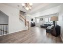 Bright living area with wood floors, staircase, stylish furniture, and modern lighting at 18726 E Yale Cir # D, Aurora, CO 80013