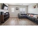 Comfortable living room with a corner sofa, modern flooring, and natural light at 18726 E Yale Cir # D, Aurora, CO 80013