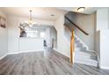 Open living space with hardwood floors, staircase, and a view of the kitchen at 18726 E Yale Cir # D, Aurora, CO 80013