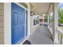 Close up front door and the inviting entryway of this home with views from the porch at 8545 Braun Loop, Arvada, CO 80005