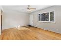 Bright living room with hardwood floors, a ceiling fan, and a large window at 805 38Th St, Boulder, CO 80303