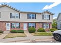 Traditional townhouse exterior with brick and siding, complemented by a well-maintained front yard at 16251 E 17Th Pl # C, Aurora, CO 80011