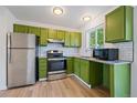 Updated kitchen featuring stainless steel appliances, green cabinetry and a light countertop at 16251 E 17Th Pl # C, Aurora, CO 80011