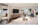 Bright living room with modern furnishings and an open floor plan to the dining area at 740 N Pearl St # 503, Denver, CO 80203