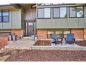 Inviting front porch area with chairs, planters, and a stylish entrance, enhancing curb appeal at 13588 W Exposition Dr, Lakewood, CO 80228