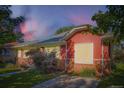 Charming single-Gathering home with a red exterior, brick foundation and a well-maintained lawn at 1273 S Jackson St, Denver, CO 80210