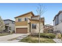 Two-story home with a brown garage door, light-yellow siding, and a landscaped front yard at 10808 Salida St, Commerce City, CO 80022