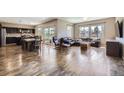 Open-concept living area boasts hardwood floors, stylish furniture, and abundant natural light at 10808 Salida St, Commerce City, CO 80022