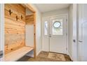 Charming entryway with wood accents, a convenient built-in bench, and a welcoming 'Welcome' mat at 18045 Sunburst Dr, Monument, CO 80132