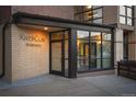 Street level view of brick condo entrance with glass entryway and visible 'Riverclay Residences' signage at 2240 N Clay St # 501, Denver, CO 80211