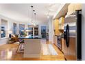 Modern kitchen boasts stainless appliances, an island with seating, and views of the city skyline at 2240 N Clay St # 501, Denver, CO 80211
