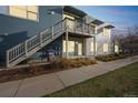 Modern condo building with staircase and private balcony, showcasing contemporary architecture and inviting curb appeal at 2809 Syracuse Ct # 129, Denver, CO 80238