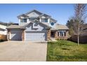 Inviting two-story home with a neatly manicured lawn, a two-car garage, and a welcoming entrance at 1009 Monarch Way, Superior, CO 80027