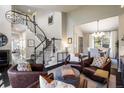 Open living area with staircase, hardwood floors, and stylish furniture, creating a comfortable and inviting atmosphere at 1009 Monarch Way, Superior, CO 80027
