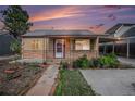 Charming home with a well-maintained front yard, walkway, and covered porch with a metal awning and decorative posts at 1910 S King St, Denver, CO 80219