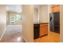 An interior showcasing a functional kitchen with stainless steel appliances and a spacious living area at 8467 Canyon Rim Cir # 302, Englewood, CO 80112