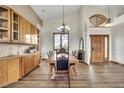 A large dining room features custom cabinets, vaulted ceiling and ample windows at 15125 Spring Valley Rd, Larkspur, CO 80118