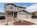 Charming two-story home featuring a three-car garage, well-maintained yard and welcoming front porch at 27615 E Archer Ave, Aurora, CO 80018
