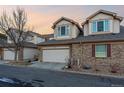Townhouse features a two-car garage and brick accents at 3035 S Indiana St, Lakewood, CO 80228