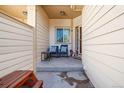 Inviting front porch with chairs, table and decor at 3035 S Indiana St, Lakewood, CO 80228