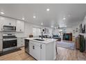 Bright kitchen with stainless steel appliances flows into the living area, perfect for entertaining at 1143 Hummingbird Cir, Longmont, CO 80501