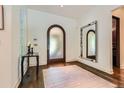 Inviting foyer with a decorative tile floor, stylish mirror, and arched doorway at 235 Eudora St, Denver, CO 80220