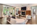 Cozy living room featuring a fireplace, large windows, and modern decor at 235 Eudora St, Denver, CO 80220